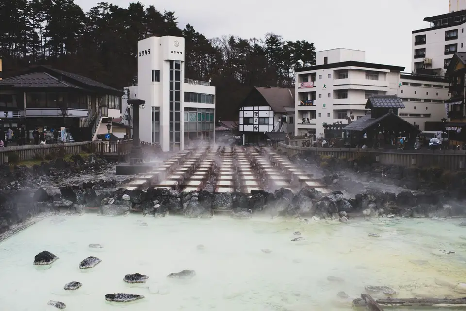 Steam rising from hot spring water in a traditional onsen town