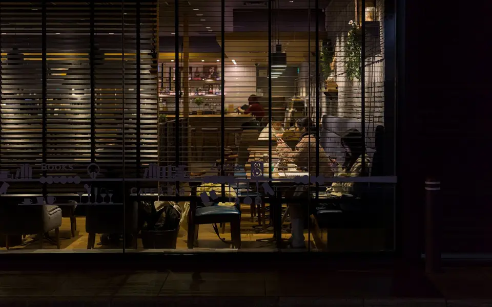 A quiet café seen through its window at night
