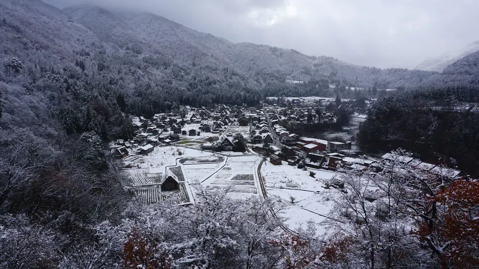 Aerial view of Shirakawa-go's thatched houses under deep snow