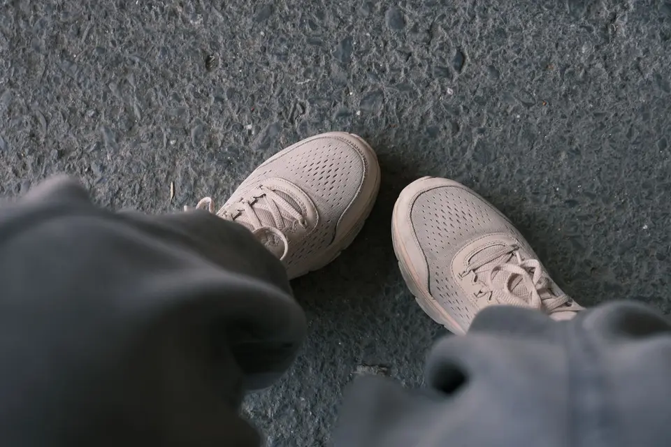 White sneakers on a city pavement