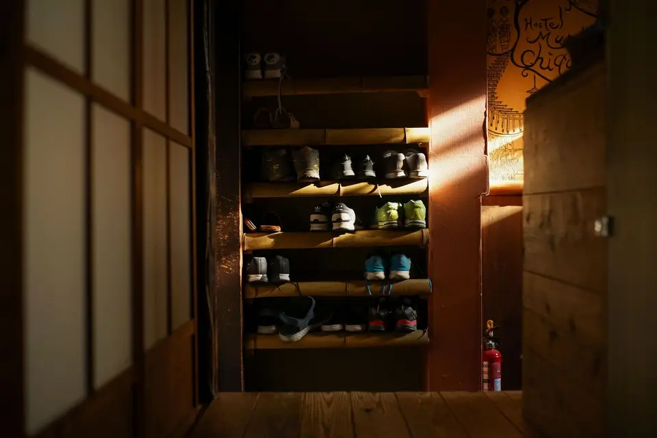 A shoe rack inside the entrance of a traditional house in Kyoto